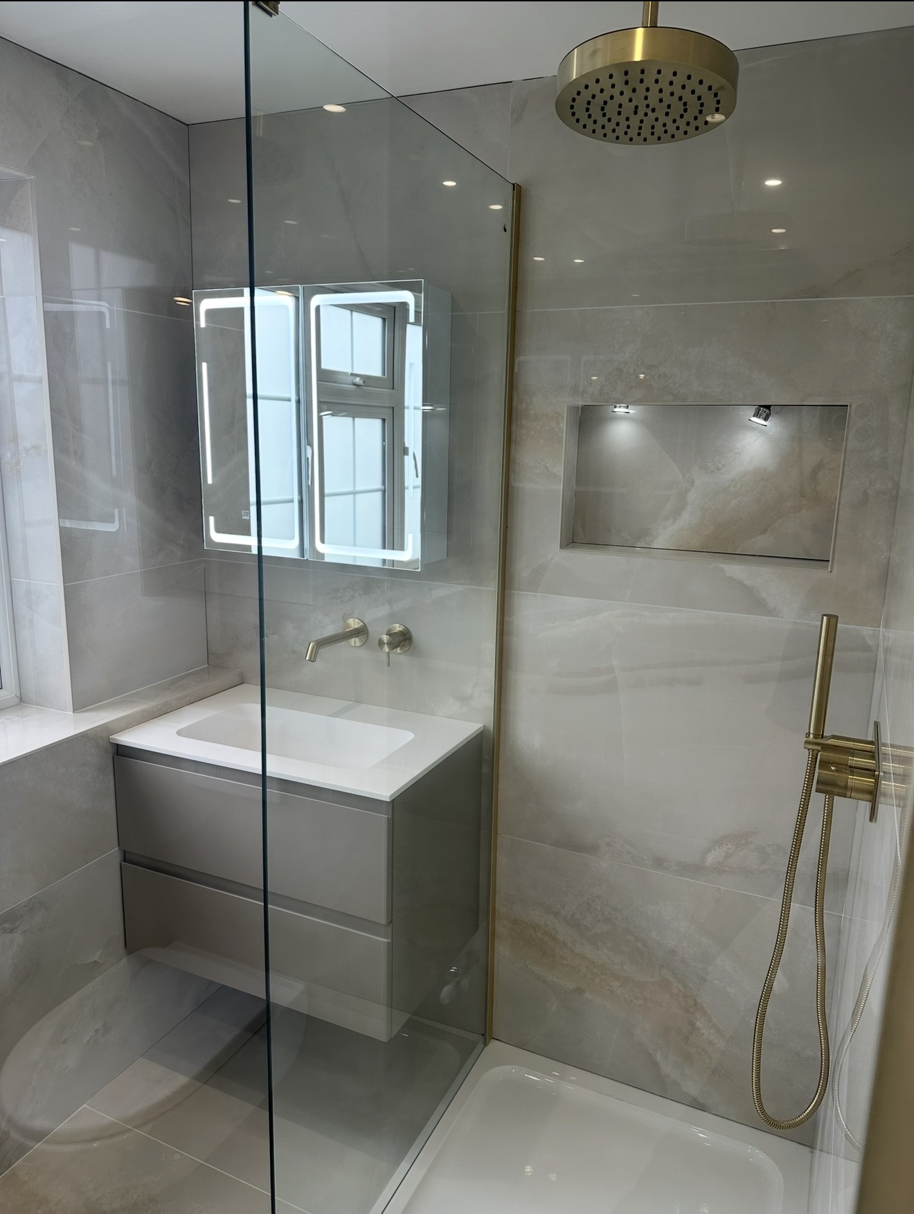Modern loft bathroom with brass shower fittings